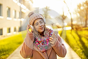 Happy young woman with headphones and cell phone