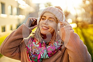 Happy young woman with headphones and cell phone