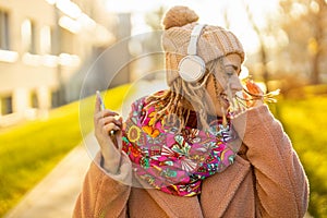 Happy young woman with headphones and cell phone