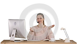 Happy young woman in headset looking at camera and talking on white background.