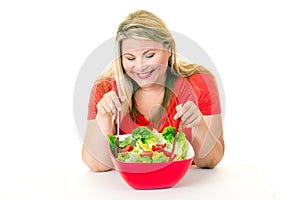 Happy young woman with healthy bowl of salad