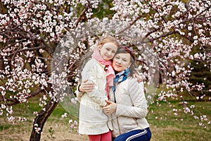 Happy young woman with her little baby girl. Mother walking with daughter on a spring day. Parent and kid enjoying