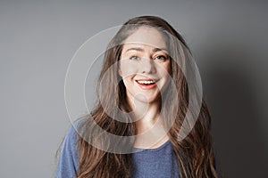 Happy young woman in her 20s with big toothy smile