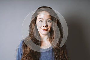 Happy young woman in her 20s with long brunette hair