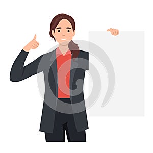 Happy young woman holding a blank or empty sheet of white paper or board