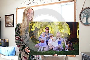 Happy Young Woman Holding Canvas Print of Family Portrait