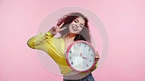 happy young woman holding clock and