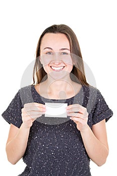 Happy young woman holding empty blank paper credit card and showing