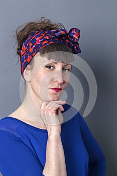 Happy young woman holding her chin to stare and reproach