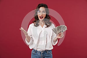 Happy young woman holding money