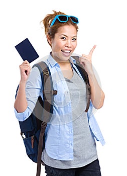 Happy young woman holding passport
