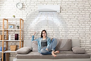 Woman Relaxing Under The Air Conditioner