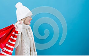 Happy young woman holding shopping bags