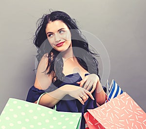 Happy young woman holding shopping bags