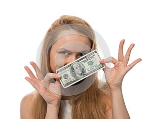 Happy young woman holding up cash money of one hundred dollars i