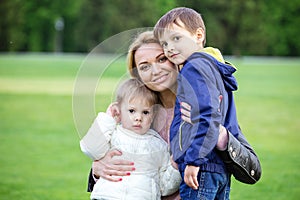 Happy young woman hugging sons