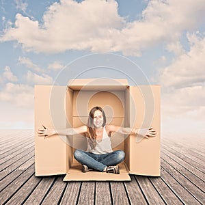 Happy young woman inside a Box