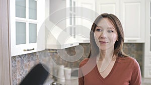 Happy young woman during interview with journalist. Reporter with microphone interviews girl at home kitchen. Blogger