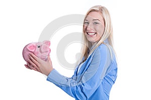 Happy young woman isolated with a pink piggy bank.