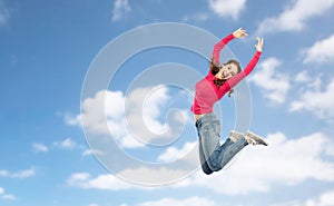 Happy young woman jumping in air or dancing