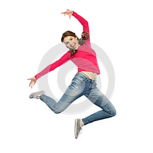 Happy young woman jumping in air or dancing
