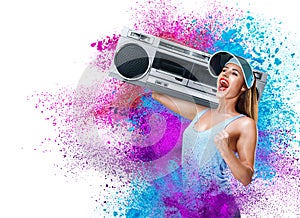 Happy young woman listening music with boombox