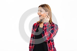 Happy young woman listening music with earphones.