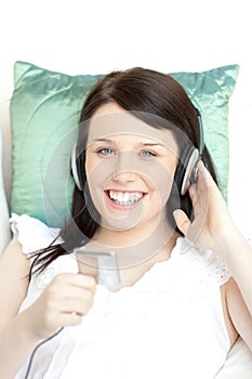 Happy young woman listening music with headphones