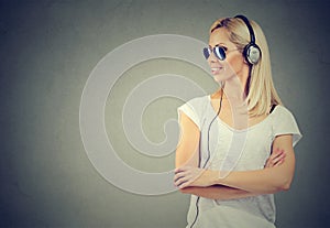 Happy young woman listening to music with headphones