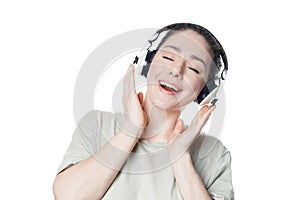 Happy young woman listening to music with headphones