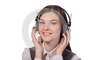 Happy young woman listening to music via headphones