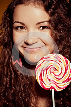 Happy young woman with lollipop