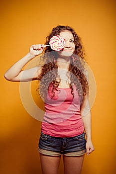 Happy young woman with lollipop