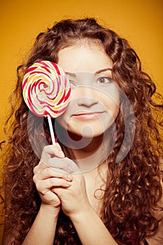 Happy young woman with lollipop