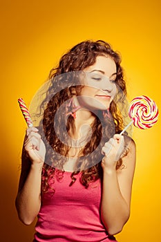 Happy young woman with lollipop