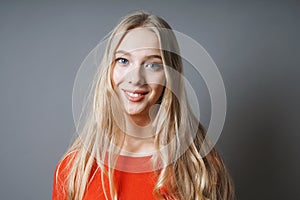 Happy young woman with long blond hair and radiant smile