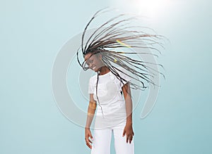 Happy young woman with long braids having fun