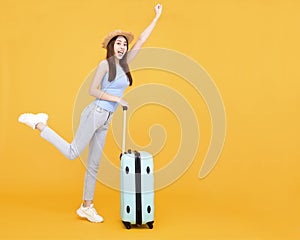 Happy young woman with  luggage isolated on yellow background ,summer,travel concept