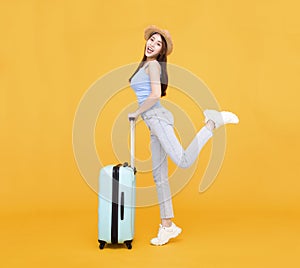 Happy young woman with  luggage isolated on yellow background ,summer,travel concept