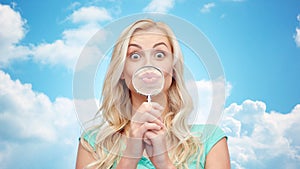 Happy young woman with magnifying glass