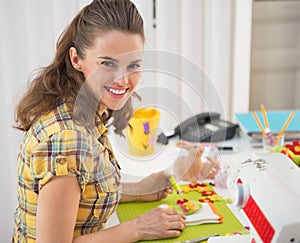 Happy young woman making easter decoration