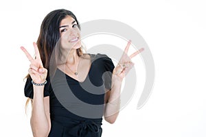 Happy young woman making peace sign with two fingers hands standing isolated over white background in Victory palm gesture concept