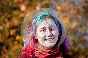 Happy young woman with multicoloured streaks hair