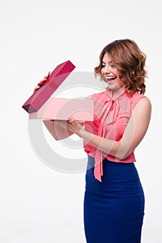 Happy young woman opening gift box