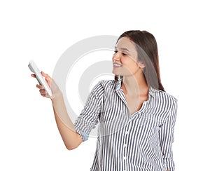 Happy young woman operating air conditioner with remote control on white