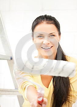 Happy young woman with paintroller