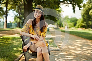 Happy young woman in the park outdoor in summer