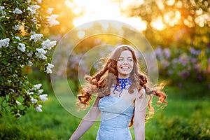 Happy young woman in a park in spring lilac