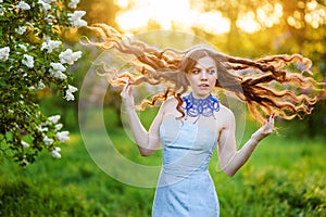 Happy young woman in a park in spring lilac