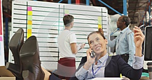 Happy young woman on the phone in a warehouse office 4k